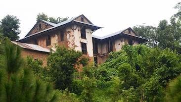 monastic building surrounded by plants in (sindhuli?) village-366x206